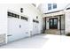 View of the two-car garage and covered front porch with stone steps leading to a wood door at 617 Darian Woods Dr, Holly Springs, NC 27540