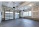 Spacious garage features ample lighting and multiple garage doors for easy access at 617 Darian Woods Dr, Holly Springs, NC 27540