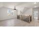 Well-lit hallway with wood floors and staircase with modern railing at 617 Darian Woods Dr, Holly Springs, NC 27540