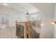 Bright hallway with hardwood floors, elegant chandelier, and stylish railing at 617 Darian Woods Dr, Holly Springs, NC 27540