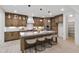 Modern kitchen with island, granite countertops, stainless steel appliances, and custom cabinetry at 617 Darian Woods Dr, Holly Springs, NC 27540