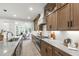 Bright eat-in kitchen boasts wood cabinets, stainless appliances and white marble countertops and backsplash at 617 Darian Woods Dr, Holly Springs, NC 27540
