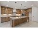 Spacious kitchen featuring modern cabinetry, large island, and stainless steel appliances at 617 Darian Woods Dr, Holly Springs, NC 27540