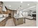 Stylish kitchen with an island, stainless appliances, and an open view to the staircase and living room at 617 Darian Woods Dr, Holly Springs, NC 27540