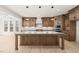 An enormous kitchen with a big island with wooden legs, lots of cabinetry, and stainless steel appliances at 617 Darian Woods Dr, Holly Springs, NC 27540
