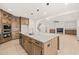 Contemporary kitchen with a central island, stainless steel appliances, and view of the fireplace at 617 Darian Woods Dr, Holly Springs, NC 27540