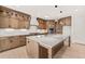 A large kitchen with a central island, stainless steel appliances, and modern cabinetry at 617 Darian Woods Dr, Holly Springs, NC 27540