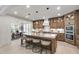 Charming kitchen with wood cabinets, stainless steel appliances, and a spacious island with bar seating at 617 Darian Woods Dr, Holly Springs, NC 27540