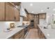 Beautiful kitchen features wood cabinets, stainless steel appliances and white marble countertops at 617 Darian Woods Dr, Holly Springs, NC 27540