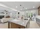 Open concept kitchen with large island, stainless sink and view into the living and dining areas at 617 Darian Woods Dr, Holly Springs, NC 27540