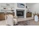 Living area showcasing fireplace with shelves, plush chair, area rug, and modern decor at 617 Darian Woods Dr, Holly Springs, NC 27540