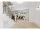 Bright, open living area with hardwood flooring, a staircase, and a view of the backyard at 617 Darian Woods Dr, Holly Springs, NC 27540