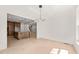 A bright living space with wainscotting and crown molding with view into the kitchen at 617 Darian Woods Dr, Holly Springs, NC 27540