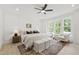 Airy and bright main bedroom with tray ceilings, and a sitting area with a green outdoor view at 617 Darian Woods Dr, Holly Springs, NC 27540