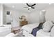 Bright main bedroom with a ceiling fan, natural wood flooring, and paneled accent wall at 617 Darian Woods Dr, Holly Springs, NC 27540