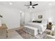 Calming main bedroom with a ceiling fan, paneled walls, and two bedside tables at 617 Darian Woods Dr, Holly Springs, NC 27540