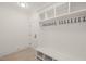Mudroom with a built-in bench, coat hooks, and storage shelves at 617 Darian Woods Dr, Holly Springs, NC 27540