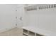 Bright mudroom featuring storage bench, coat hooks, and a door to the exterior at 617 Darian Woods Dr, Holly Springs, NC 27540