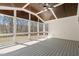Relaxing screened porch featuring a vaulted ceiling, ceiling fan, and ample space to unwind at 617 Darian Woods Dr, Holly Springs, NC 27540
