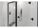 Walk-in shower featuring a glass enclosure, shower head, and white tile at 617 Darian Woods Dr, Holly Springs, NC 27540