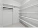 A walk-in closet with ample shelving and a hanging rod for optimal storage solutions at 617 Darian Woods Dr, Holly Springs, NC 27540