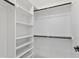 A functional walk-in closet offers storage with white shelving and hanging rods at 617 Darian Woods Dr, Holly Springs, NC 27540