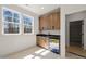 This wet bar features granite countertops, wooden cabinets and stainless steel mini fridge at 617 Darian Woods Dr, Holly Springs, NC 27540