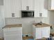 White cabinets, black hardware, and a built-in microwave at 6644 Sheriff Watson Rd, Sanford, NC 27332