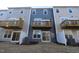 Townhome backyards with patios, balconies, and privacy fences under a clear sky at 2325 Bay Minette Sta # 548, Apex, NC 27502
