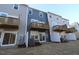 View of townhome backyards featuring sliding doors to balconies above and patios below at 2325 Bay Minette Sta # 548, Apex, NC 27502