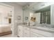 Bright bathroom with dual sinks, white cabinets, and a view into the Primary bedroom at 2325 Bay Minette Sta # 548, Apex, NC 27502