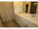 Bright bathroom featuring double sinks, quartz countertop, and tiled shower with glass doors at 2325 Bay Minette Sta # 548, Apex, NC 27502