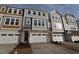 Townhouse featuring stone accents, a two-car garage, and a welcoming front entrance at 2325 Bay Minette Sta # 548, Apex, NC 27502