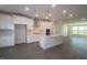 Kitchen featuring white cabinets, large island, stainless appliances, and vinyl flooring at 2325 Bay Minette Sta # 548, Apex, NC 27502