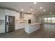 Bright kitchen with stainless steel appliances, island, recessed lights, and dark vinyl floors at 2325 Bay Minette Sta # 548, Apex, NC 27502
