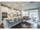 Bright kitchen open to the dining area featuring white cabinets and island seating at 2325 Bay Minette Sta # 548, Apex, NC 27502