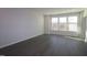 Bright and empty living room features recessed lights, white walls and trim, and vinyl floors at 2325 Bay Minette Sta # 548, Apex, NC 27502