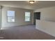 Spacious loft area with carpeted floors and two windows offering natural light at 244 Combine Trl # Dm 108, Benson, NC 27504