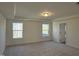 Spacious main bedroom with carpet and two windows at 244 Combine Trl # Dm 108, Benson, NC 27504