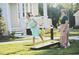 Two women enjoy playing a game of cornhole outside of their neighborhood home at 252 Beacon Dr, Pittsboro, NC 27312