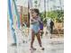 Girl enjoys the splash pad at the community's recreational park at 252 Beacon Dr, Pittsboro, NC 27312