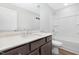 Well-lit bathroom with modern vanity, quartz countertop, framed mirror, and shower-tub combination at 324 Church St, Morrisville, NC 27560