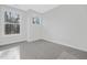 Bedroom features two windows, neutral walls, and neutral carpet at 324 Church St, Morrisville, NC 27560