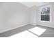Bright bedroom with natural light streaming through a window, complemented by neutral carpeting at 324 Church St, Morrisville, NC 27560