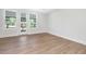 Bright, sunny bedroom featuring hardwood flooring, and large windows, offering plenty of natural light at 324 Church St, Morrisville, NC 27560
