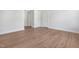 Bright, empty bedroom featuring hardwood flooring, neutral paint, and two closets at 324 Church St, Morrisville, NC 27560