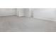A spacious room featuring neutral walls, carpet and baseboards with several doors at 324 Church St, Morrisville, NC 27560