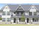 Charming townhome featuring a stone foundation and an attractive front lawn at 324 Church St, Morrisville, NC 27560