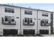 Modern townhome featuring balconies, dark garage doors and well kept landscaping at 324 Church St, Morrisville, NC 27560