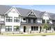 Charming townhome featuring a stone foundation and an attractive front lawn at 324 Church St, Morrisville, NC 27560
